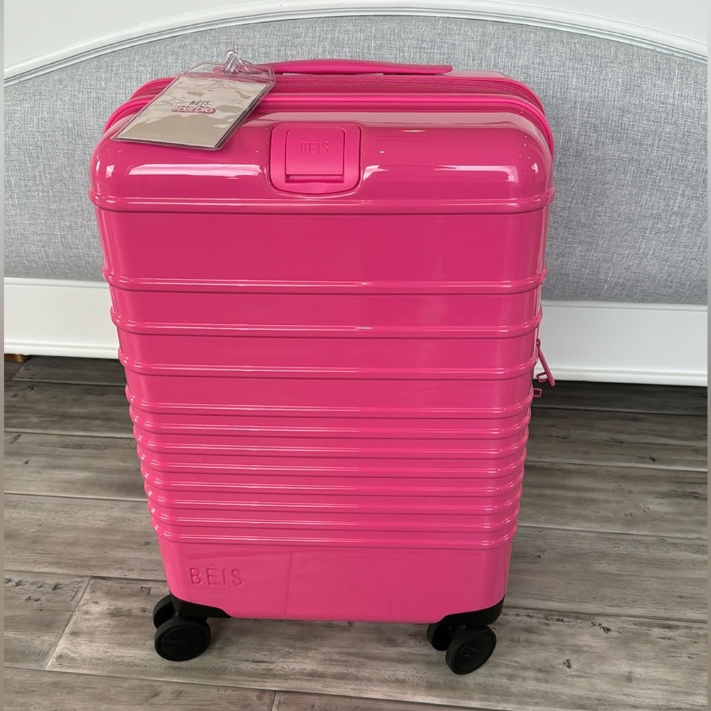 The Carry-On Roller in Barbie™ Pink (NWT) *has couple small scratches (in photo)